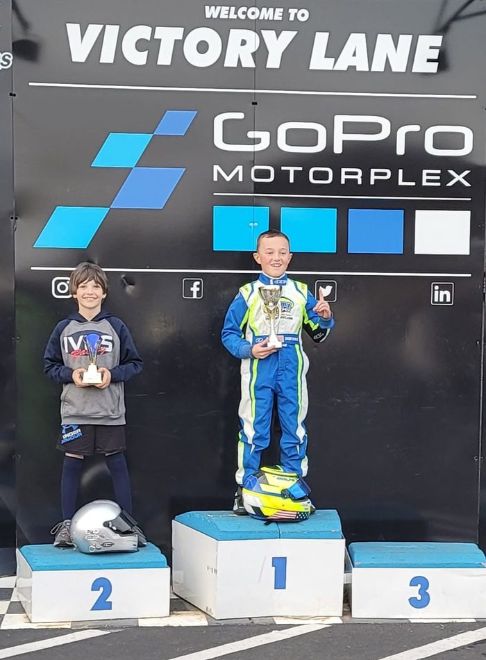 On the steps at GoPro Motorplex, now Trackhouse Motorplex.